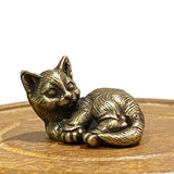 Reclining cat figurine- brass