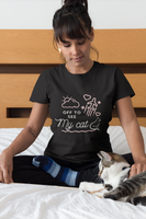woman wearing a cute graphic cat shirt while petting her cat