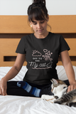 woman wearing a cute graphic cat shirt while petting her cat